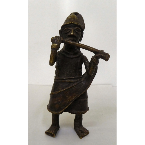 68 - An African cast metal figure, wearing native costume  9