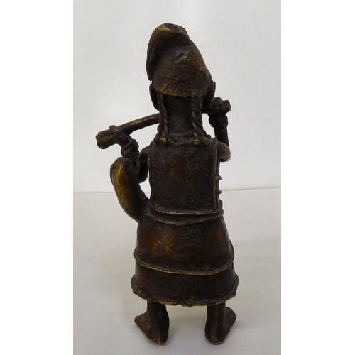 68 - An African cast metal figure, wearing native costume  9