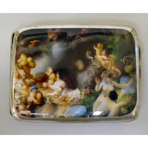 70 - A white metal folding cigarette case, bearing a pictorial fairyland scene