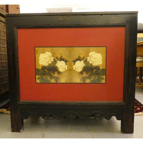 9 - A Chinese black lacquered and panelled elm cupboard with a rising upper section, raised on extended ... 