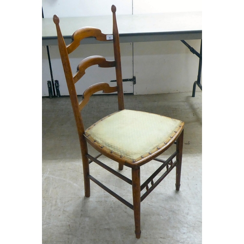 93 - A circa 1900 fruitwood framed, ladderback side chair with a stud upholstered seat pad, raised on tur... 