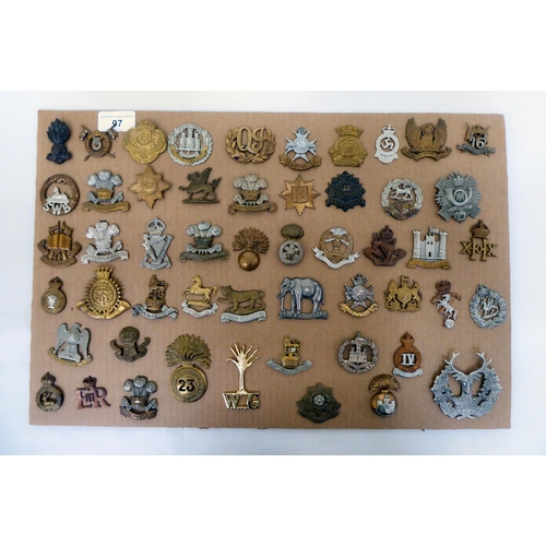 97 - Over fifty British military regimental cap badges and other insignia, some copies: to include Innisk... 