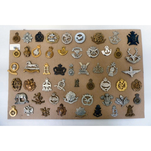 98 - Over fifty British military regimental cap badges and other insignia, some copies: to include 3rd Ki... 