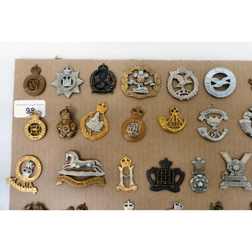 98 - Over fifty British military regimental cap badges and other insignia, some copies: to include 3rd Ki... 