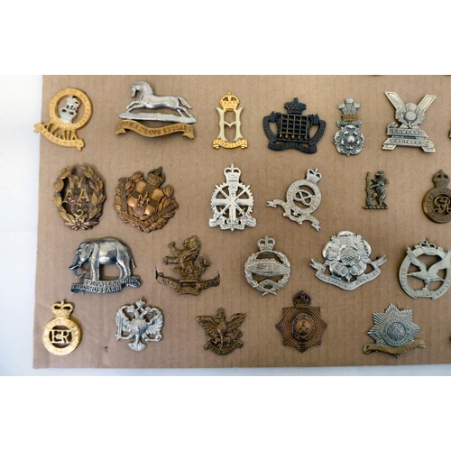 98 - Over fifty British military regimental cap badges and other insignia, some copies: to include 3rd Ki... 