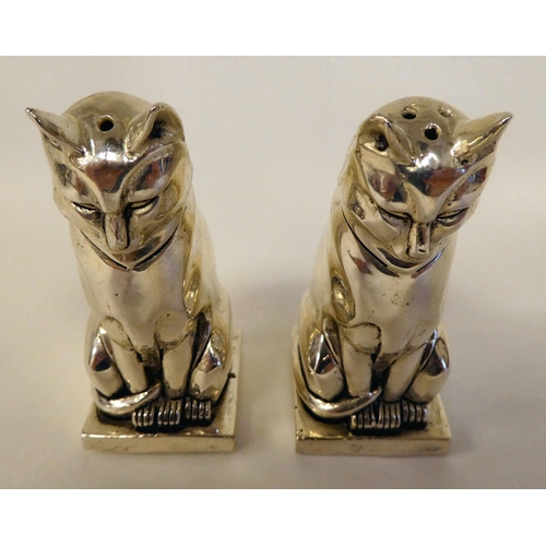 99 - A pair of Egyptian style white metal cat salt and pepper pots  stamped 800