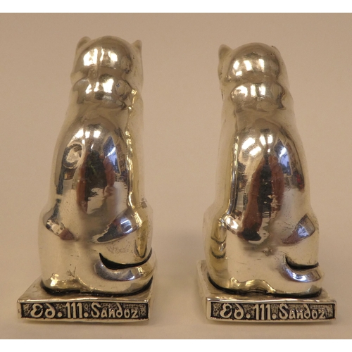 99 - A pair of Egyptian style white metal cat salt and pepper pots  stamped 800