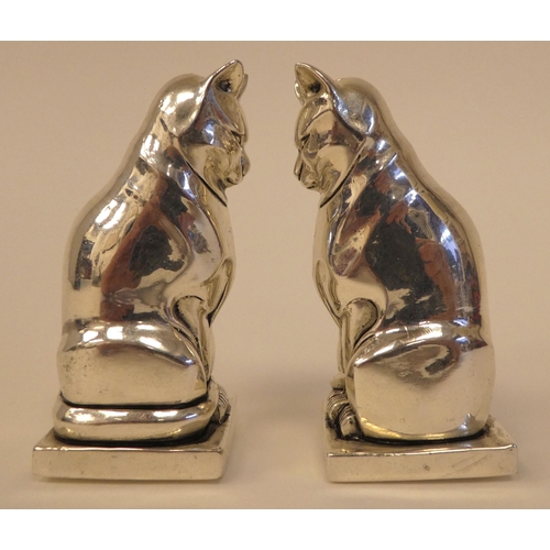 99 - A pair of Egyptian style white metal cat salt and pepper pots  stamped 800