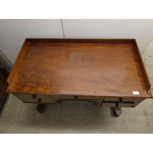 353 - A William IV mahogany desk, the top with a gallery, over five drawers, raised on opposing pillar upr... 