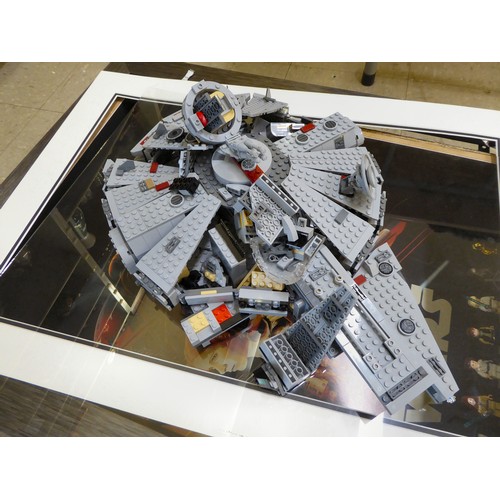 167 - A Lego Star Wars themed display, comprising seven characters and a millennium falcon in a deep set, ... 