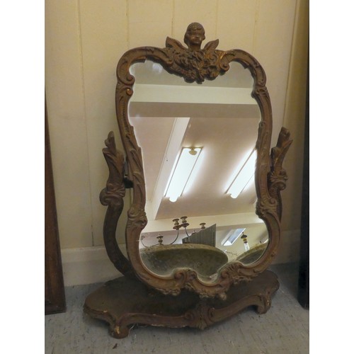 102 - A mixed lot: to include a 1930s dressing table mirror, set in an elaborately moulded gilt frame, piv... 