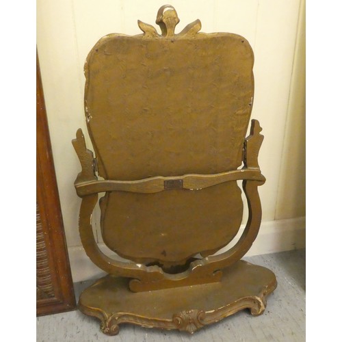 102 - A mixed lot: to include a 1930s dressing table mirror, set in an elaborately moulded gilt frame, piv... 