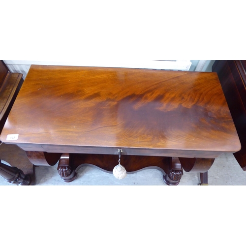 103 - A Regency style mahogany finished serving table, comprising a frieze drawer, elevated on S-shape for... 