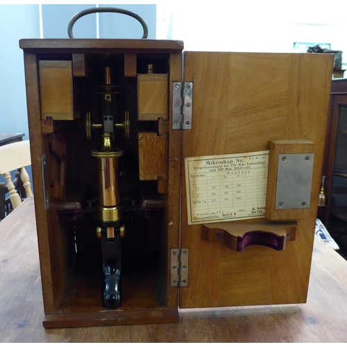 119 - An early 20thC lacquered brass and black enamel L Leitz Wetzlar microscope with two rotating lenses ... 