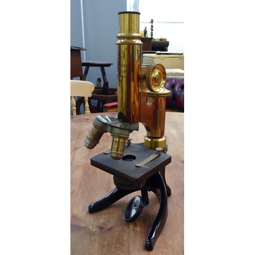 119 - An early 20thC lacquered brass and black enamel L Leitz Wetzlar microscope with two rotating lenses ... 