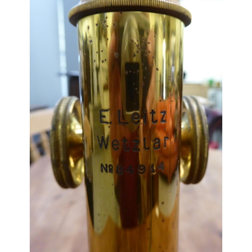 119 - An early 20thC lacquered brass and black enamel L Leitz Wetzlar microscope with two rotating lenses ... 