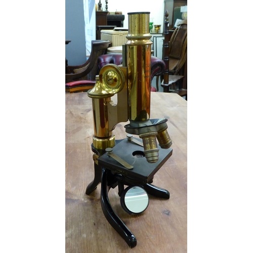 119 - An early 20thC lacquered brass and black enamel L Leitz Wetzlar microscope with two rotating lenses ... 