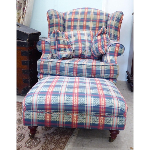 120 - A modern wingback armchair, upholstered in multi-coloured chequered fabric with a loose cushion, two... 