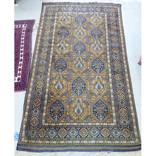 133 - A Persian rug with geometric motifs, on a brown ground  38