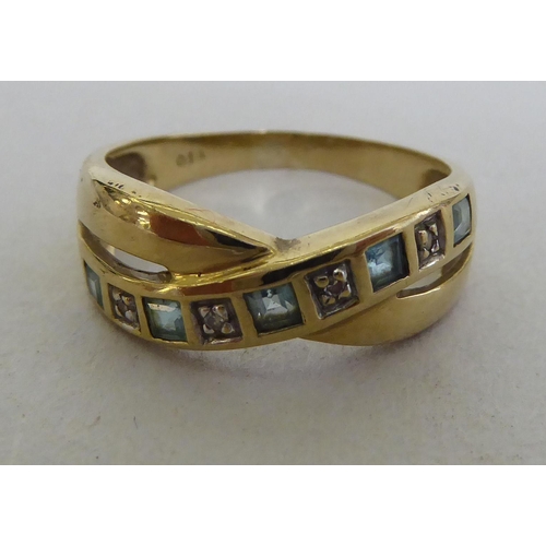 136 - A 9ct gold, diamond and blue topaz crossover ring