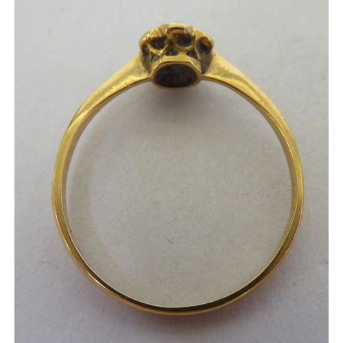 137 - An 18ct gold, diamond daisy design ring