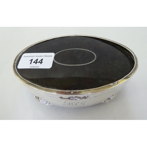 144 - A silver ring box of oval form with a tortoiseshell panel in the hinged lid  Birmingham 1912&nb... 