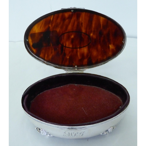 144 - A silver ring box of oval form with a tortoiseshell panel in the hinged lid  Birmingham 1912&nb... 