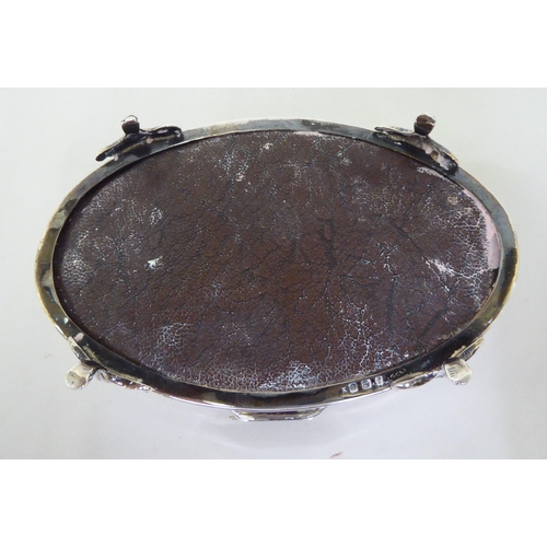 144 - A silver ring box of oval form with a tortoiseshell panel in the hinged lid  Birmingham 1912&nb... 