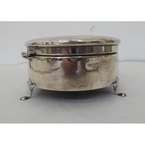 145 - A silver ring box of circular form with engraved and engine turned ornament on the hinged lid  ... 