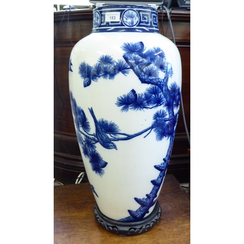 153 - A late Victorian Minton china vase, decorated in blue and white with birds and trees  24