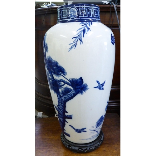 153 - A late Victorian Minton china vase, decorated in blue and white with birds and trees  24