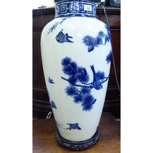 153 - A late Victorian Minton china vase, decorated in blue and white with birds and trees  24