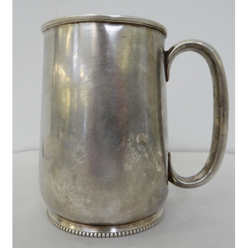 164 - Silver collectables: to include flatware; a mug; a cigarette case; and a spoon and pusher  mixe... 