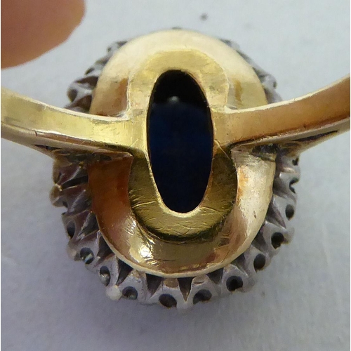 172 - An 18ct gold diamond and sapphire cluster ring