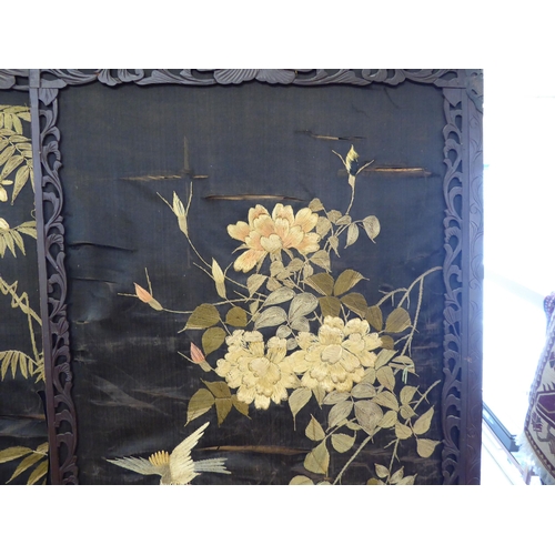 178 - An early 20thC fruitwood framed fourfold room screen with embroidered panels  each panel 66