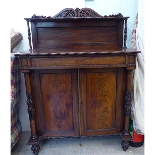 183 - A William IV mahogany chiffonier with a raised back, incorporating a shelf over a frieze drawer and ... 