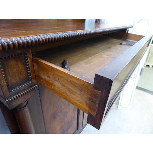 183 - A William IV mahogany chiffonier with a raised back, incorporating a shelf over a frieze drawer and ... 