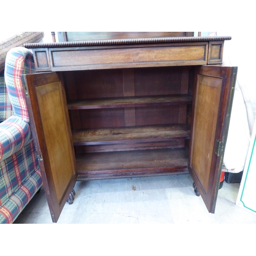 183 - A William IV mahogany chiffonier with a raised back, incorporating a shelf over a frieze drawer and ... 