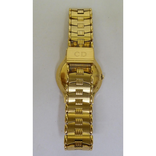 187 - A Christian Dior gold plated Quartz bracelet watch, faced by a baton dial