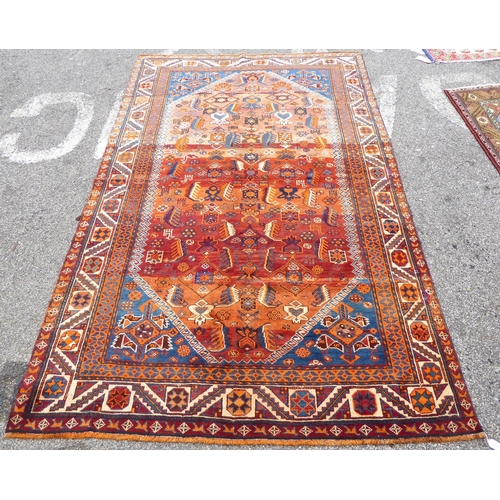 198 - A Persian rug, decorated with repeating stylised designs, on a mainly red ground  64