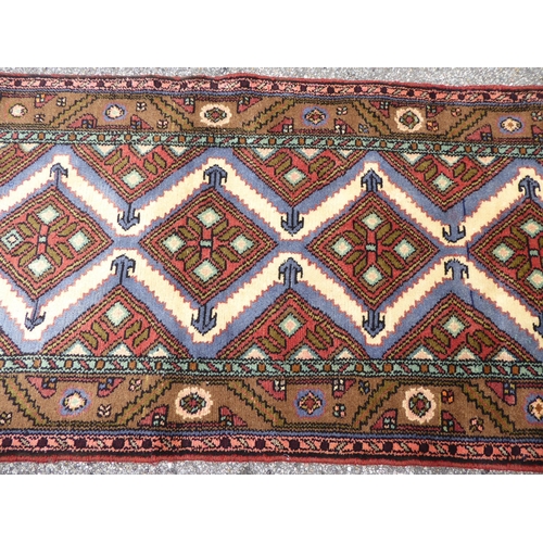 199 - A Persian runner, decorated with repeating diamond forms, on a multi-coloured ground  31