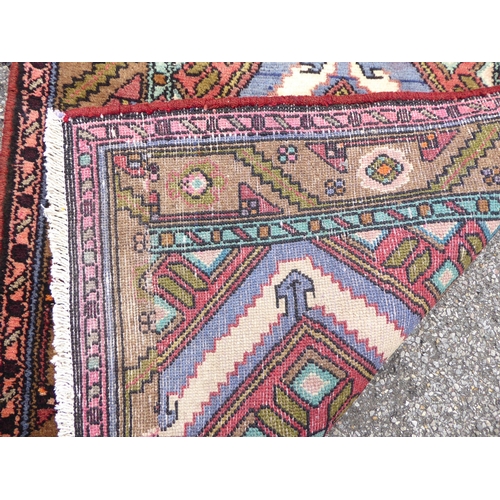 199 - A Persian runner, decorated with repeating diamond forms, on a multi-coloured ground  31