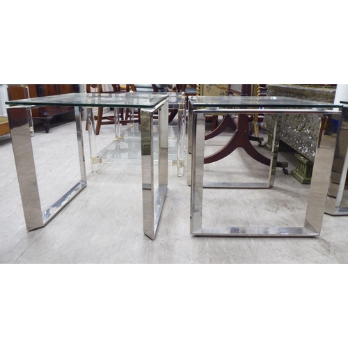 230 - A pair of modern glass topped occasional tables, raised on steel underframes  20