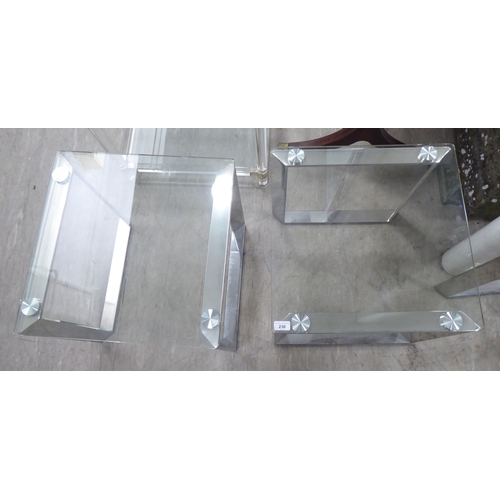 230 - A pair of modern glass topped occasional tables, raised on steel underframes  20