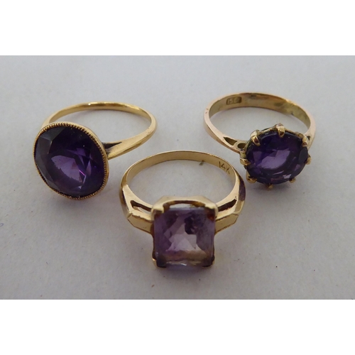 231 - Three gold coloured metal rings, set with coloured stones