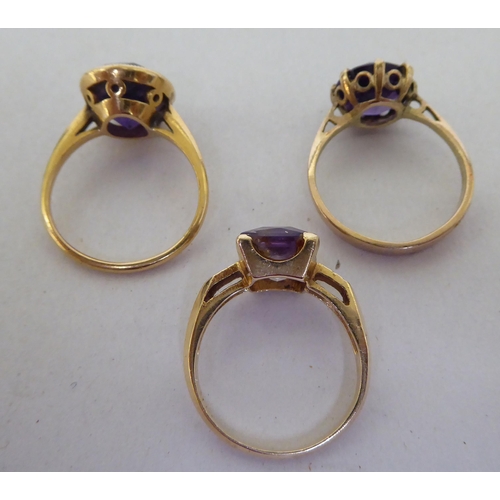 231 - Three gold coloured metal rings, set with coloured stones