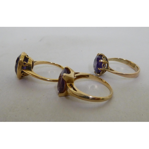 231 - Three gold coloured metal rings, set with coloured stones