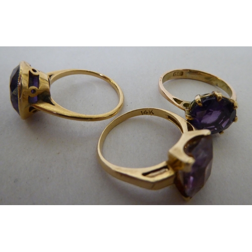 231 - Three gold coloured metal rings, set with coloured stones