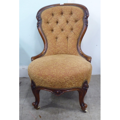 232 - A late Victorian walnut showwood framed nursing chair, part-button upholstered in floral patterned f... 