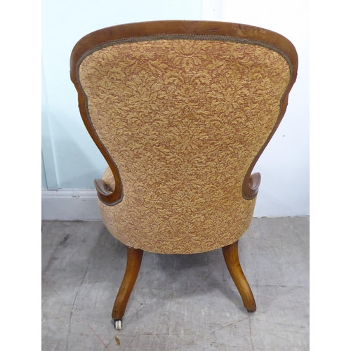 232 - A late Victorian walnut showwood framed nursing chair, part-button upholstered in floral patterned f... 